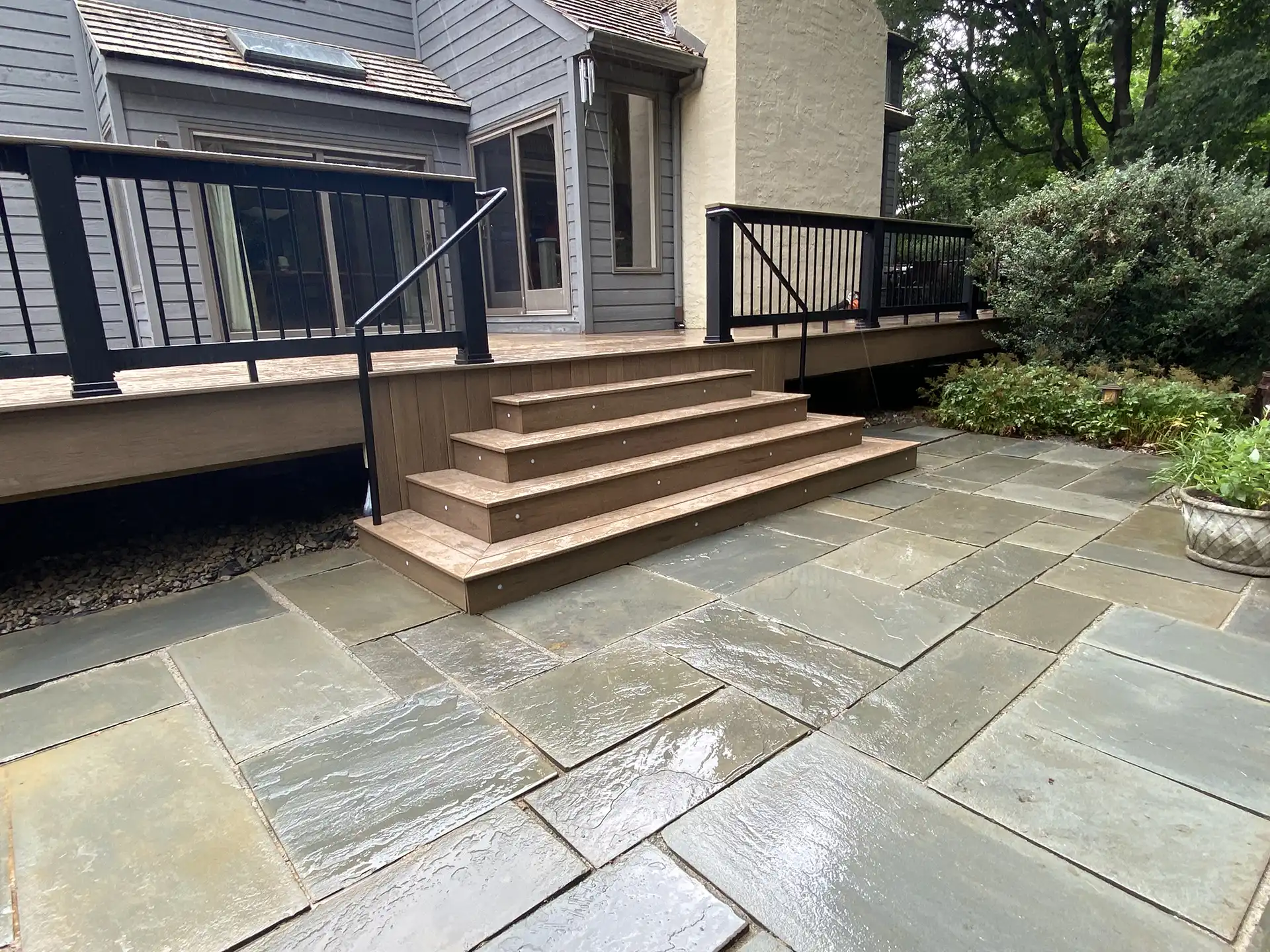 photo of a custom deck with a paver patio - Patio contractors tri-state area pennsylvania