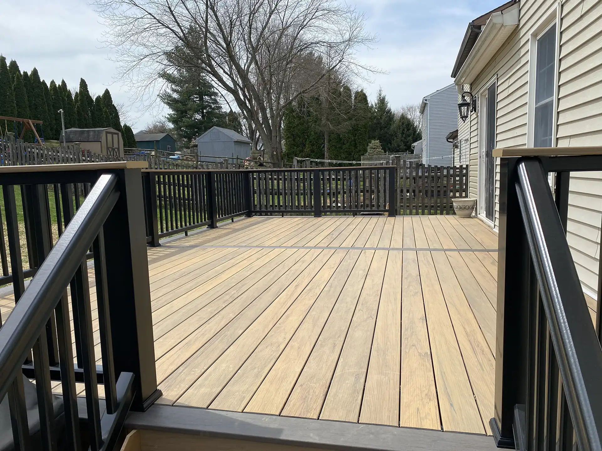 Photo of a custom deck with a composite decking material that looks like a natural wood deck - custom deck with a composite decking material - Custom Composite Deck contractors - Pennsylvania